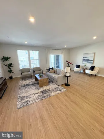 a living room with furniture window and wooden floor