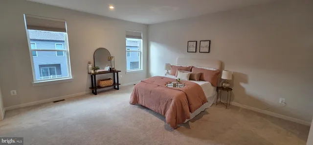 a spacious bedroom with a bed and a table in it