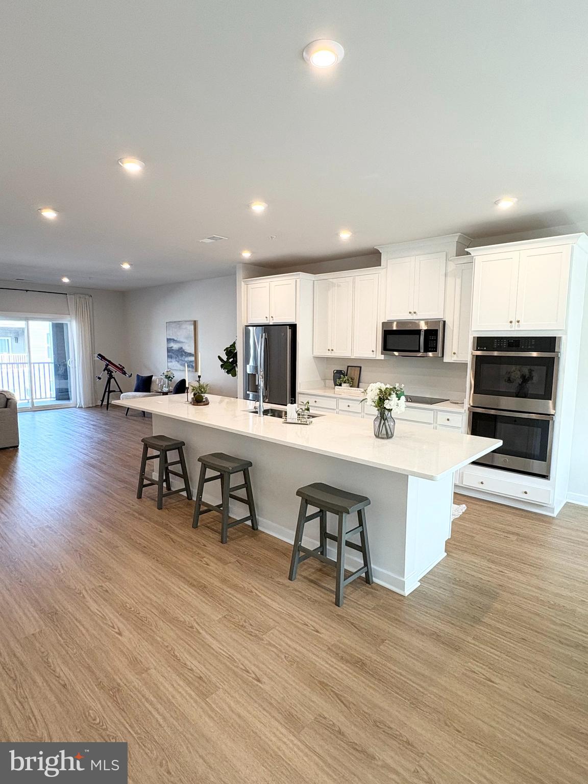 14114 Gypsum Loop, Unit 64 Chantilly, VA 20151 - Photo 2 of 40 a kitchen with stainless steel appliances kitchen island granite countertop a stove top oven a sink a counter top space and cabinets