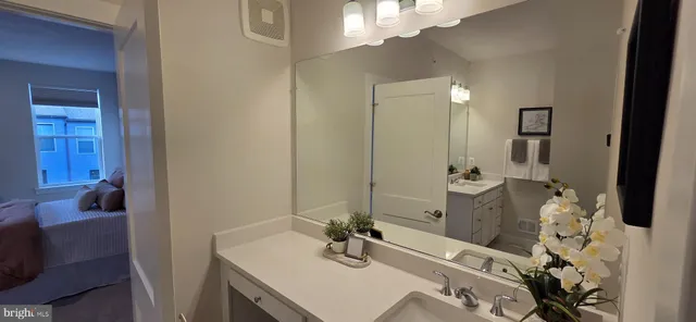 a bathroom with a sink vanity and a mirror