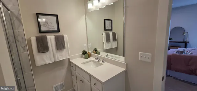 a bathroom with a sink and mirror