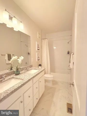 a bathroom with a granite countertop sink mirror and a