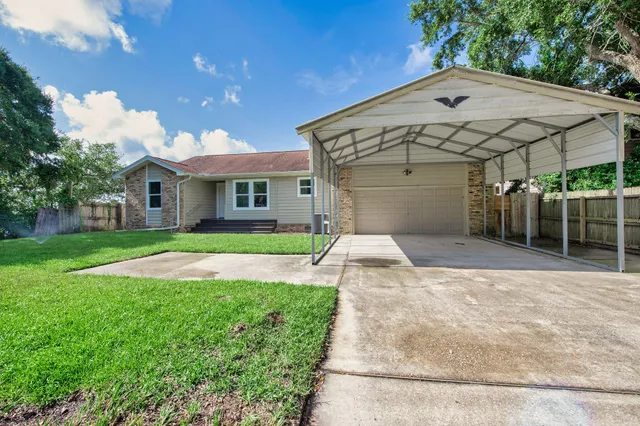 a front view of a house with yard and green space