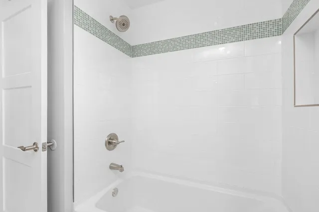 an empty room with wooden floor and fireplace