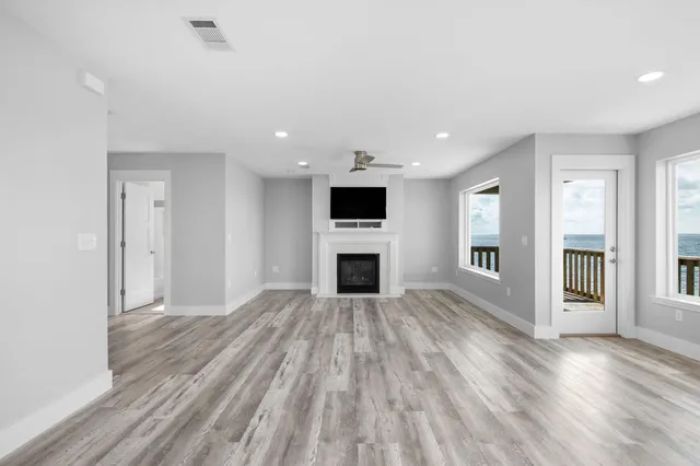 a living room with a fireplace and a flat screen tv