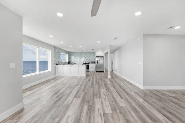 a view of a kitchen with wooden floor and a sink