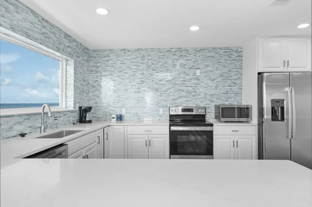 a bathroom with a sink vanity granite and a mirror