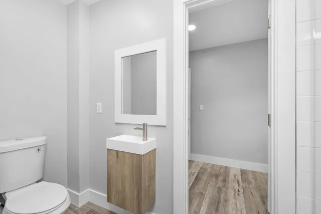 a view of a room with wooden floor and window