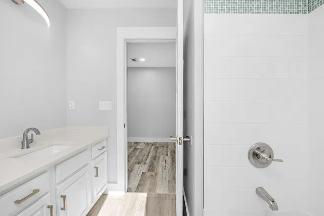 a bathroom with a sink a toilet and shower