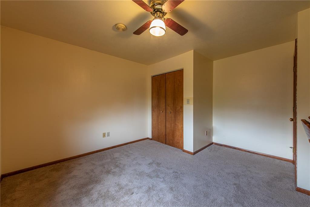 1453 Airport Road Vandergrift, PA 15690 - Photo 30 of 48 an empty room with a ceiling fan and a window