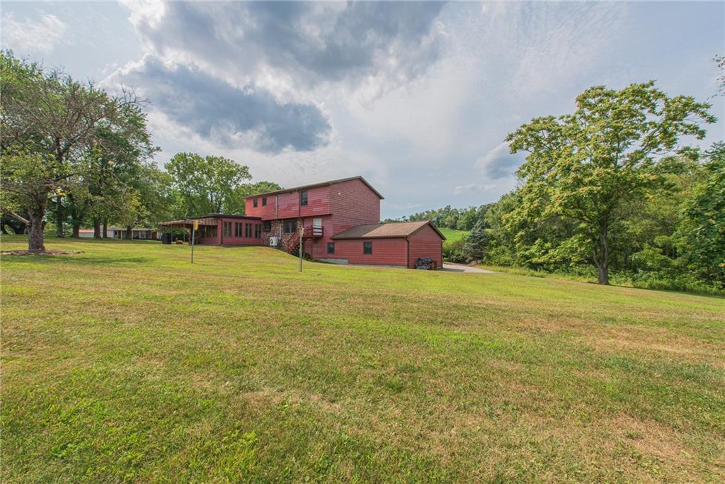 1453 Airport Road Vandergrift, PA 15690 - Photo 41 of 48 a view of a big yard with table and chairs under an umbrella