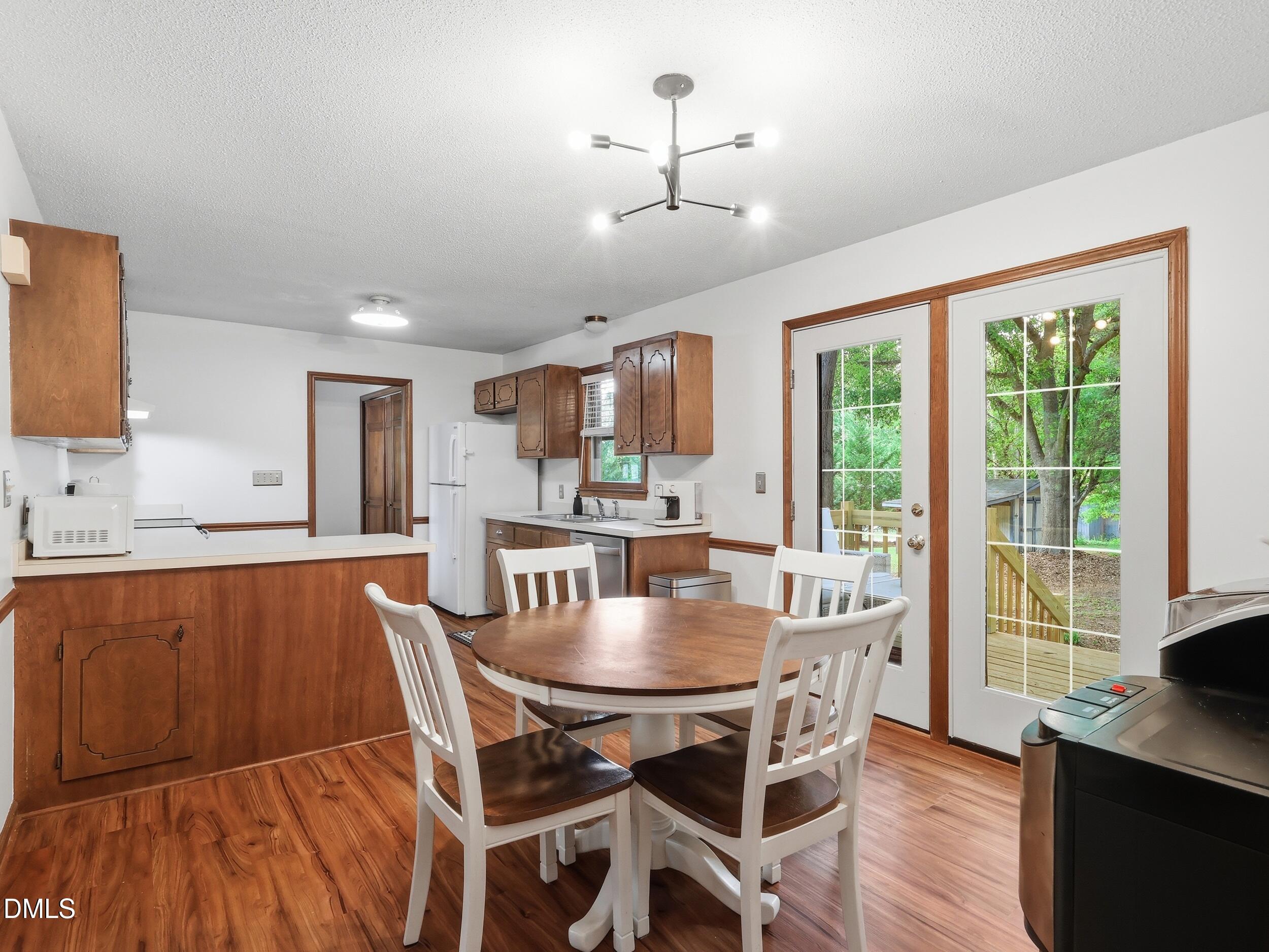 517 Lake Glad Road Wendell, NC 27591 - Photo 10 of 36 a view of a dining room with furniture window and wooden floor