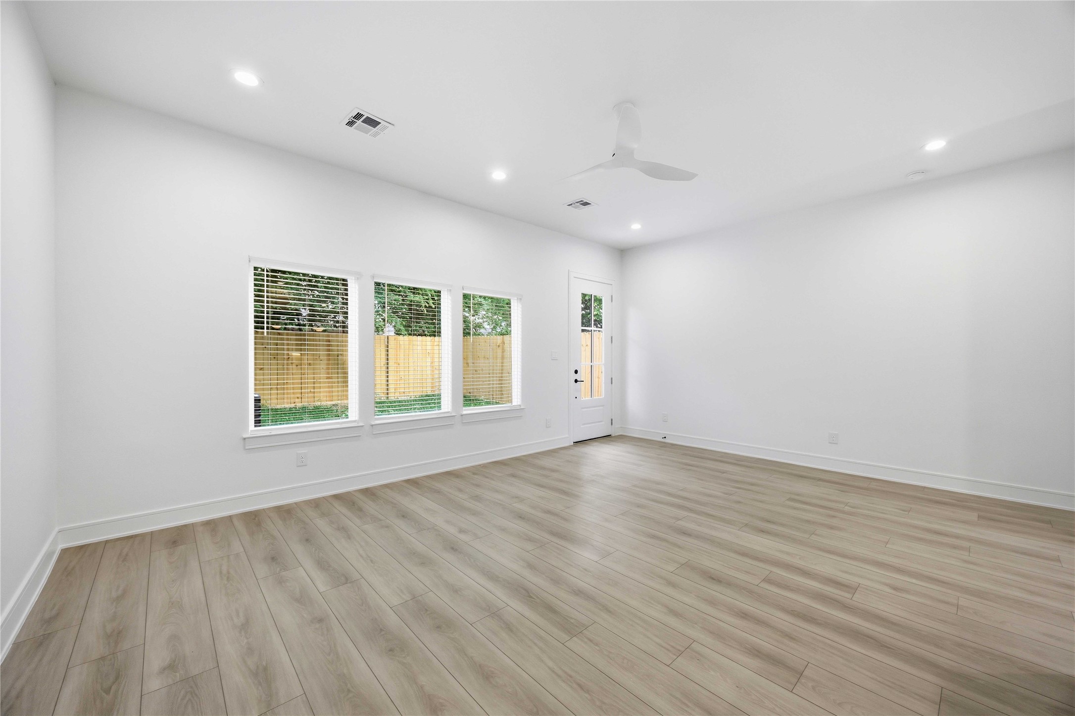 8019 Grandview Street, Unit B Houston, TX 77051 - Photo 12 of 30 an empty room with wooden floor and windows