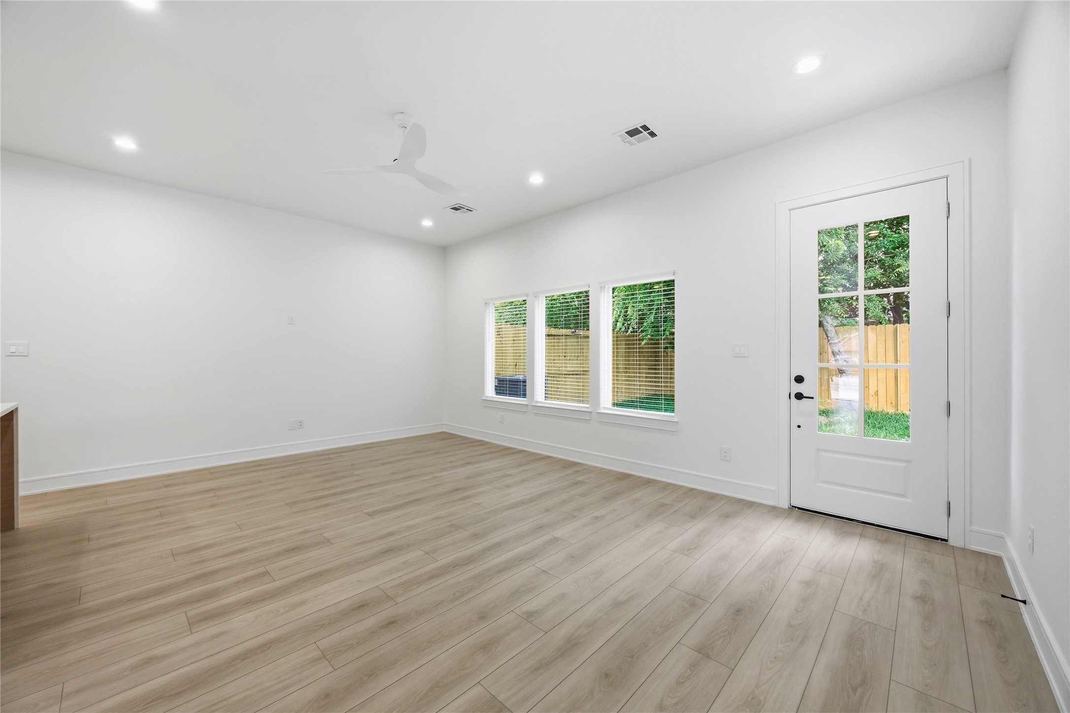 8019 Grandview Street, Unit B Houston, TX 77051 - Photo 13 of 30 an empty room with wooden floor and windows