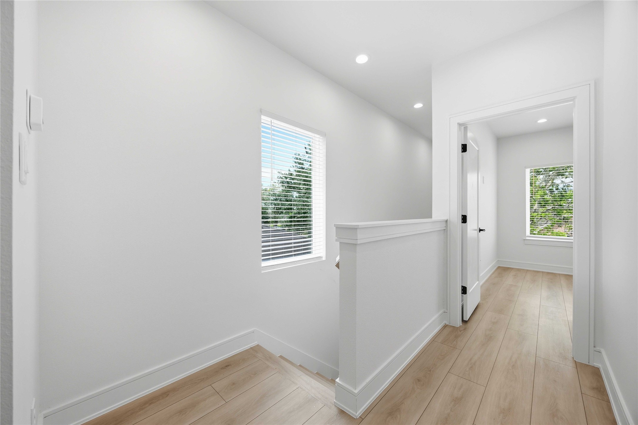 8019 Grandview Street, Unit B Houston, TX 77051 - Photo 14 of 30 wooden floor in an empty room with a window