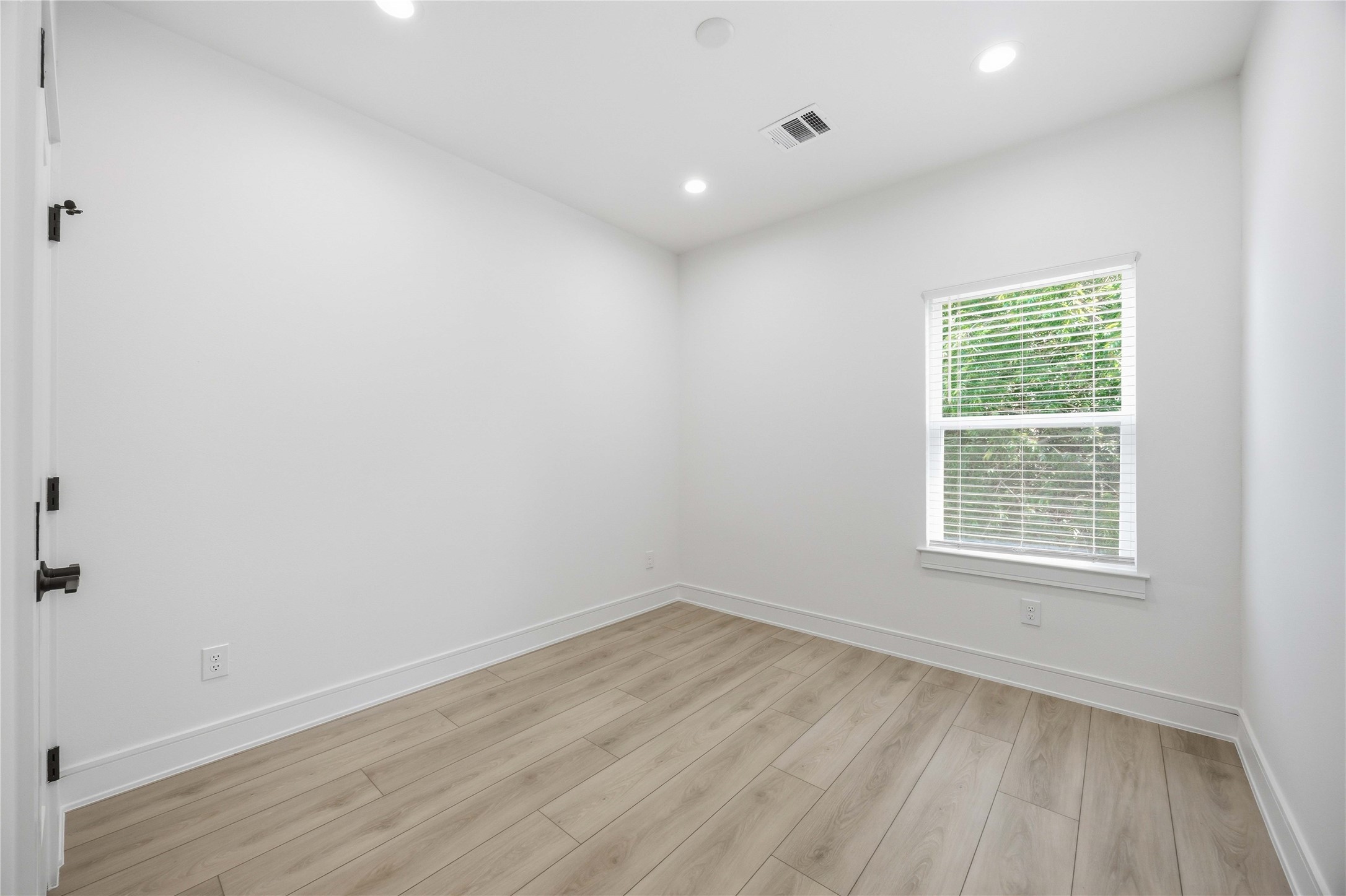 8019 Grandview Street, Unit B Houston, TX 77051 - Photo 26 of 30 wooden floor in an empty room with a window