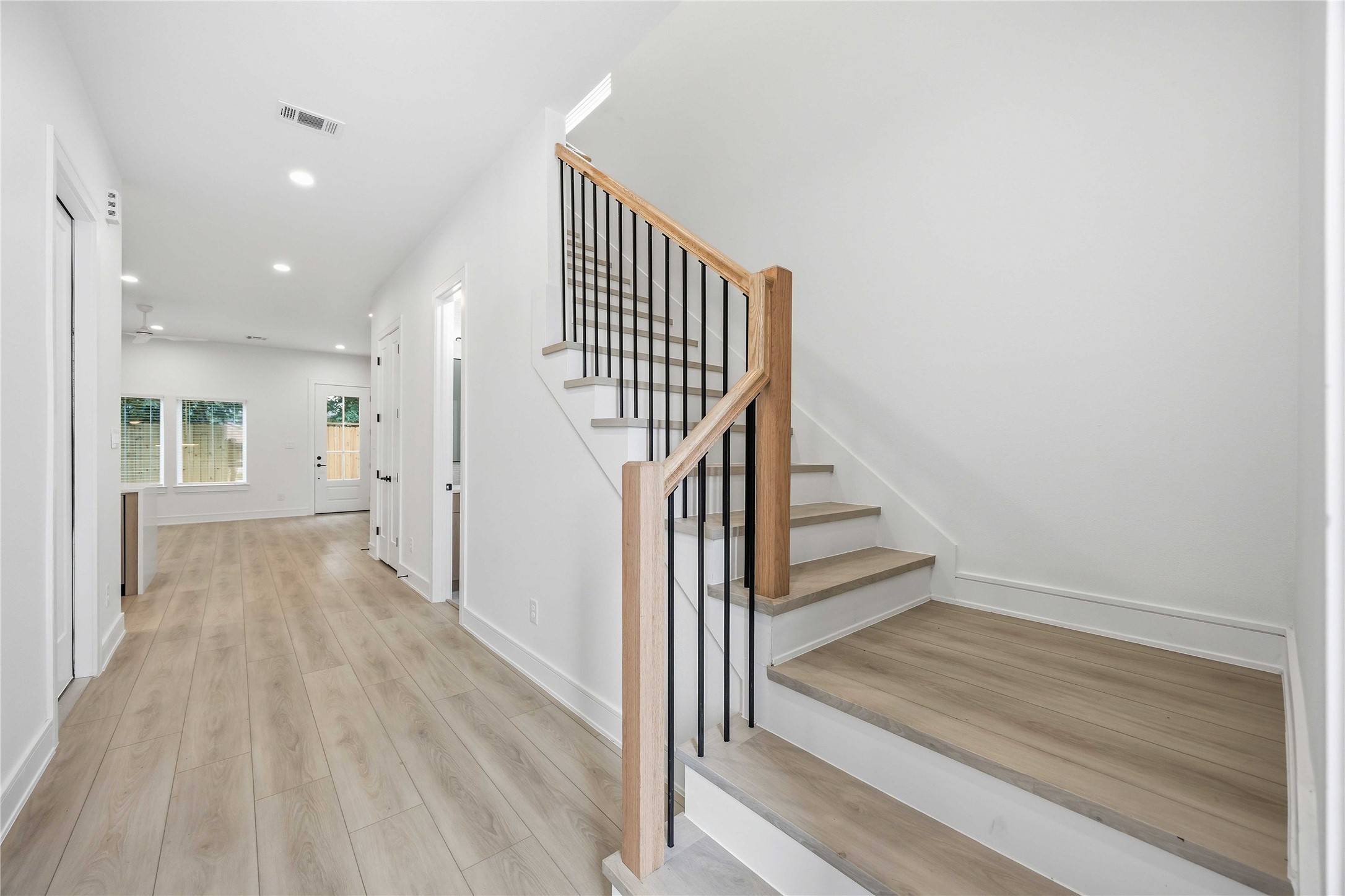 8019 Grandview Street, Unit B Houston, TX 77051 - Photo 5 of 30 a view of a hallway with wooden floor and staircase