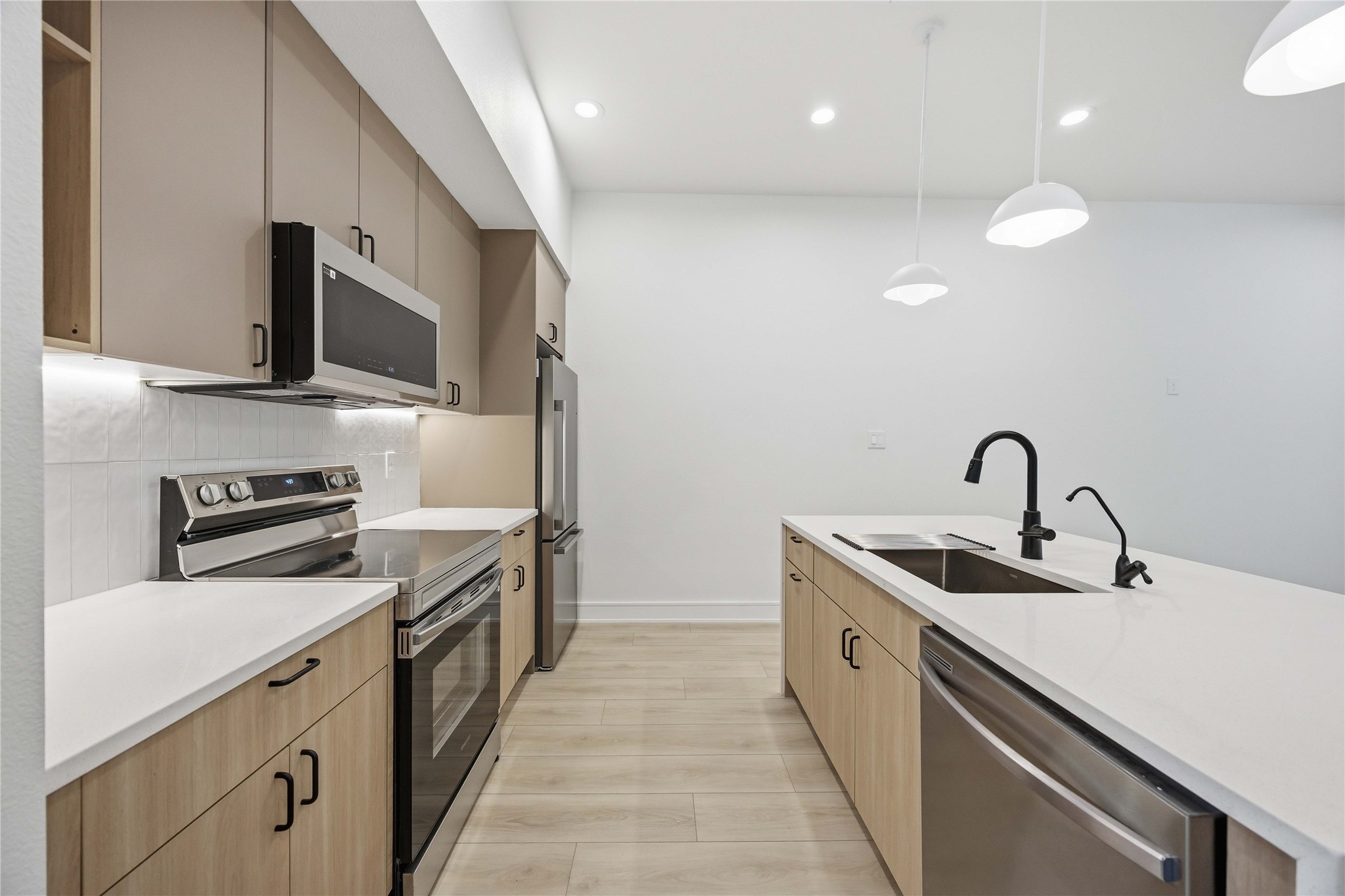 8019 Grandview Street, Unit B Houston, TX 77051 - Photo 7 of 30 a kitchen with a sink and stainless steel appliances
