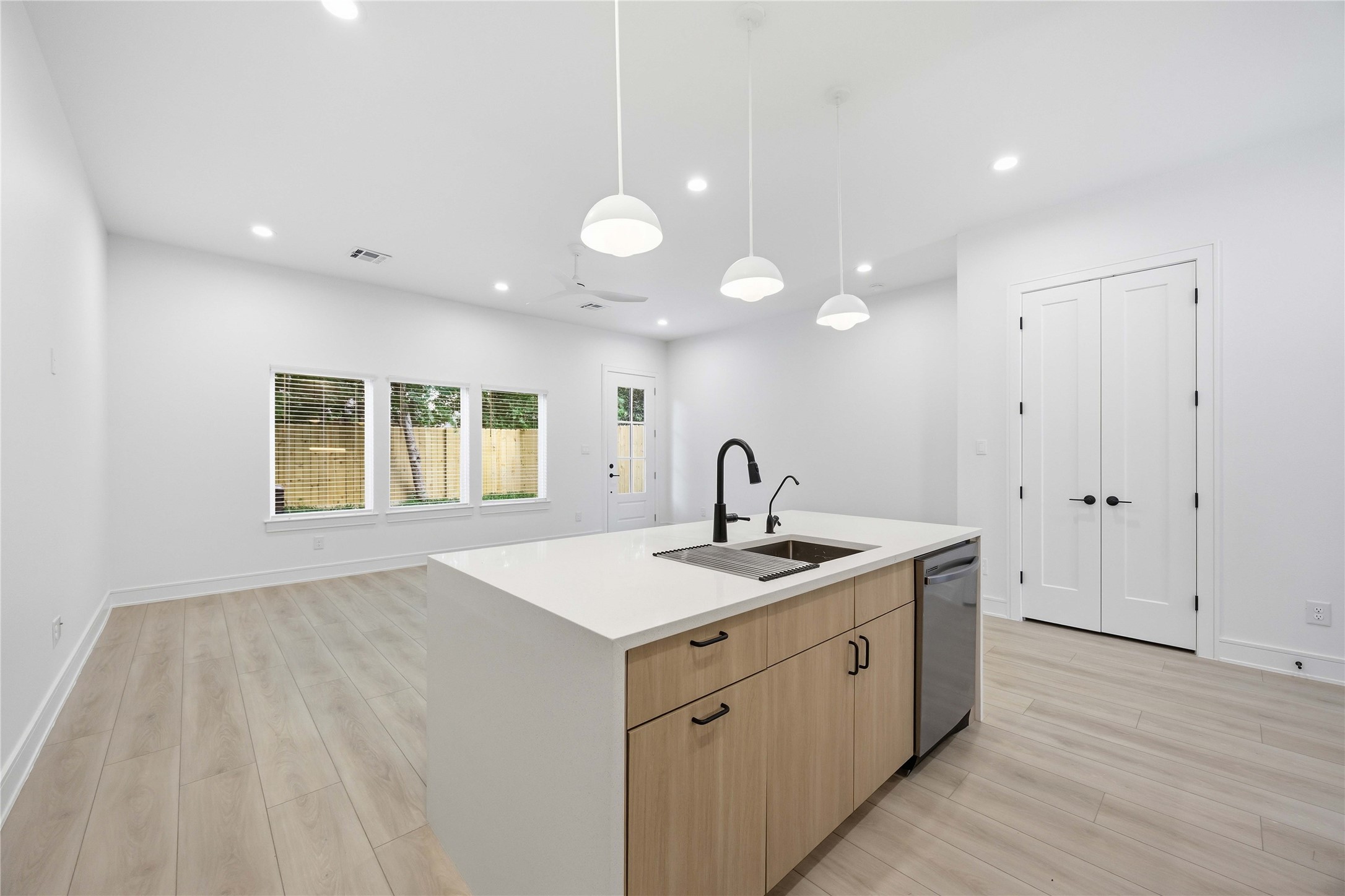 8019 Grandview Street, Unit B Houston, TX 77051 - Photo 9 of 30 a open kitchen with kitchen island a sink appliances cabinets and a large window