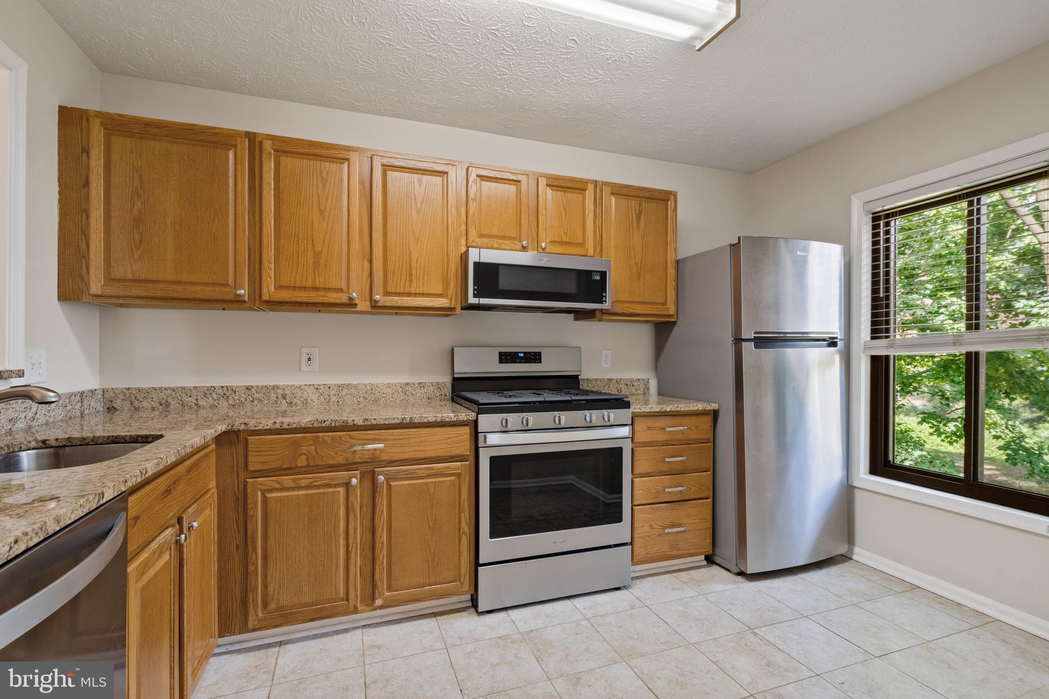 2303 Hunter's Run Drive, Unit 2303 Reston, VA 20191 - Photo 7 of 38 Kitchen with Granite and Stainless Steel Appliance