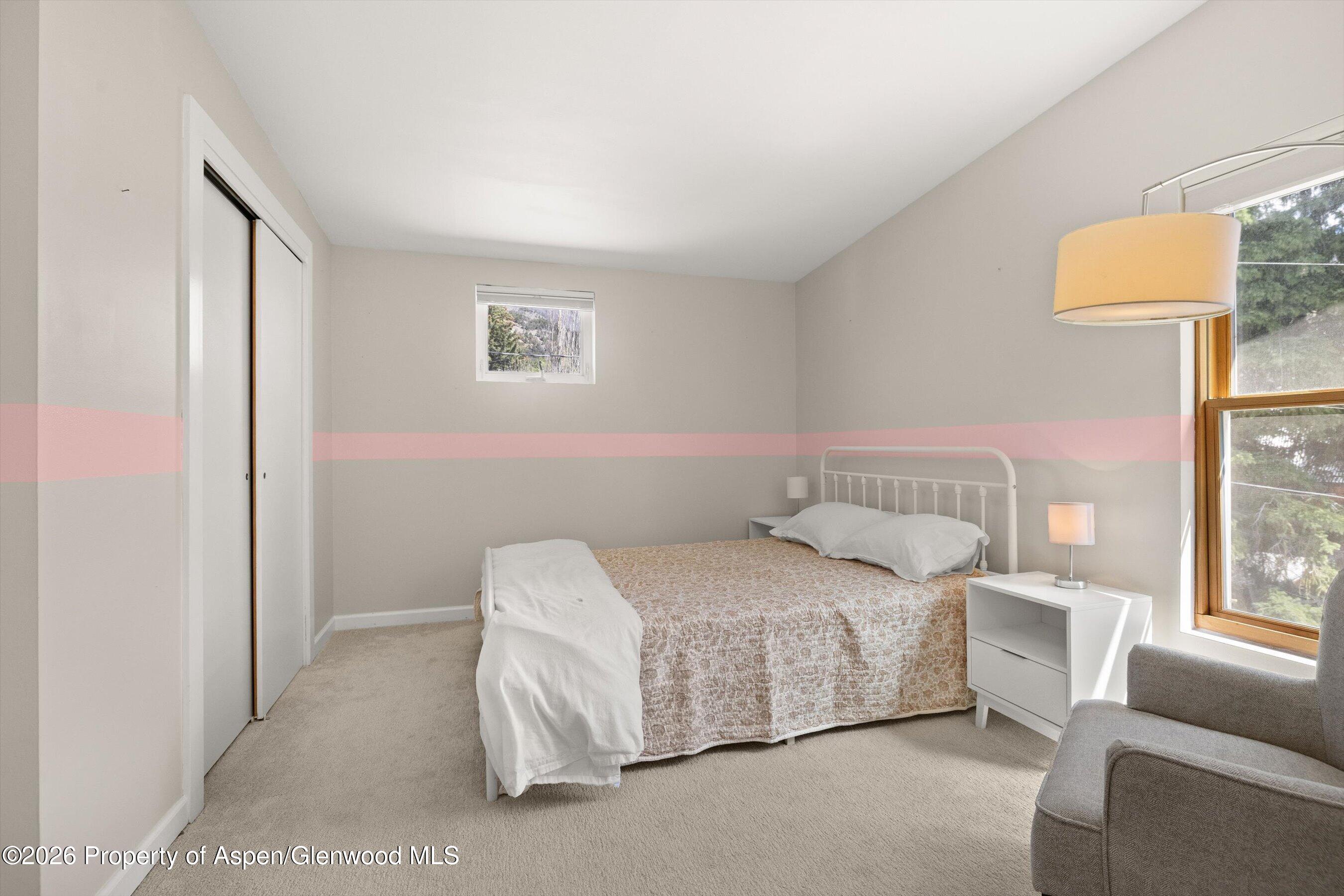 217 Longhorn Lane Basalt, CO 81621 - Photo 9 of 15 a bedroom with a bed couch and a large window