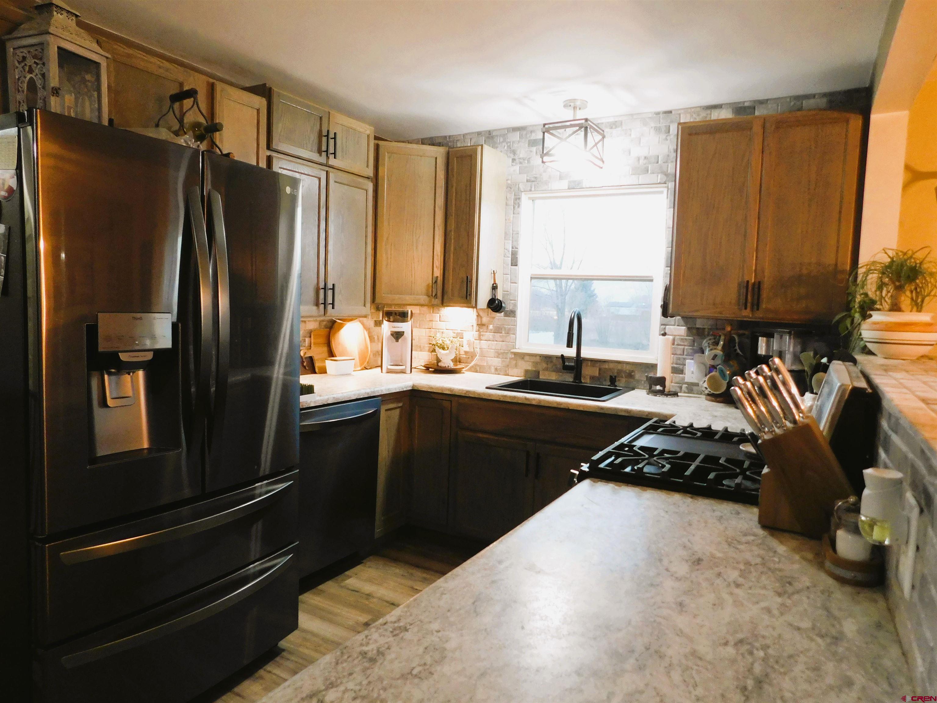14977 F Road Delta, CO 81416 - Photo 11 of 45 a kitchen with a refrigerator and a sink