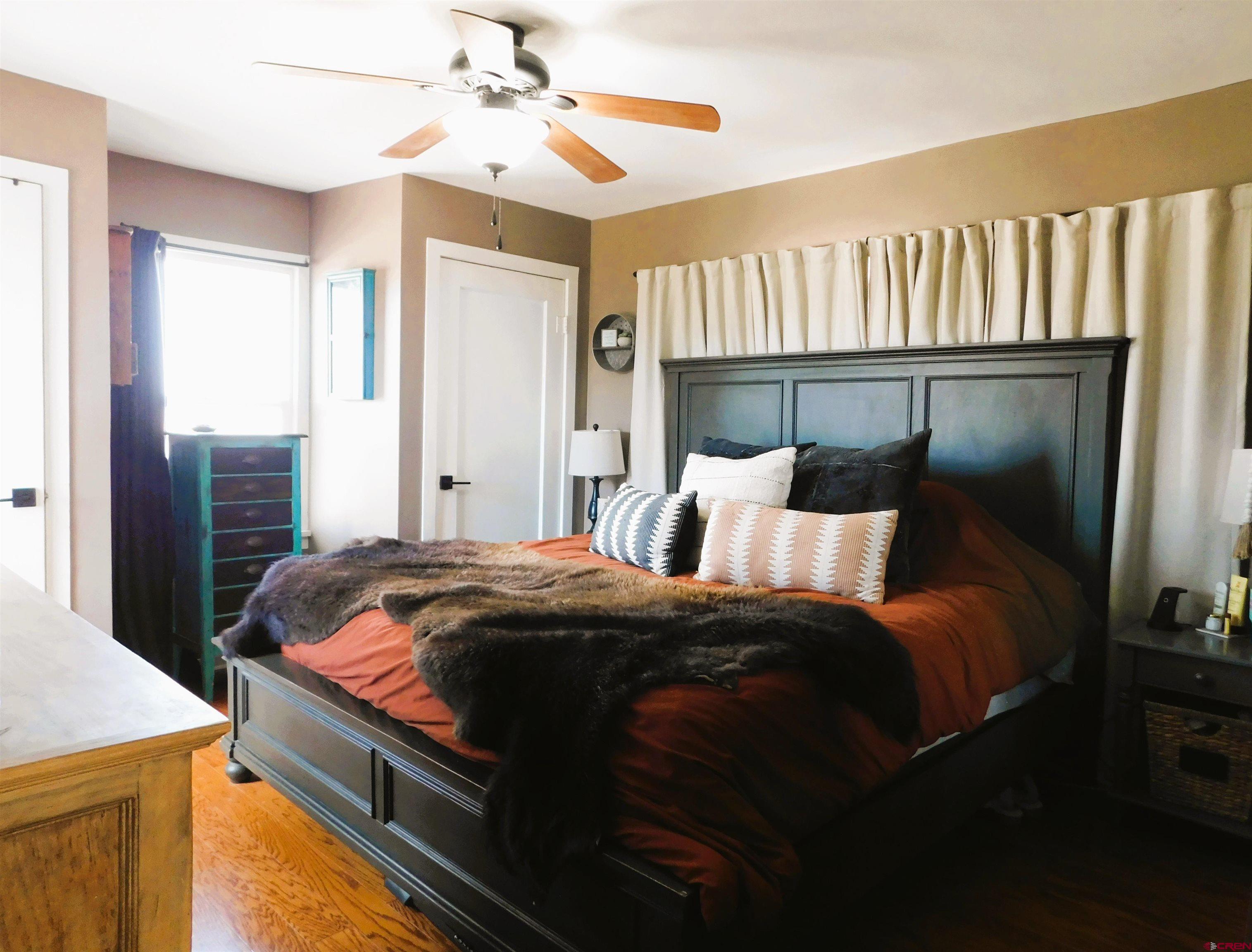 14977 F Road Delta, CO 81416 - Photo 18 of 45 a bed sitting in a bedroom next to a window