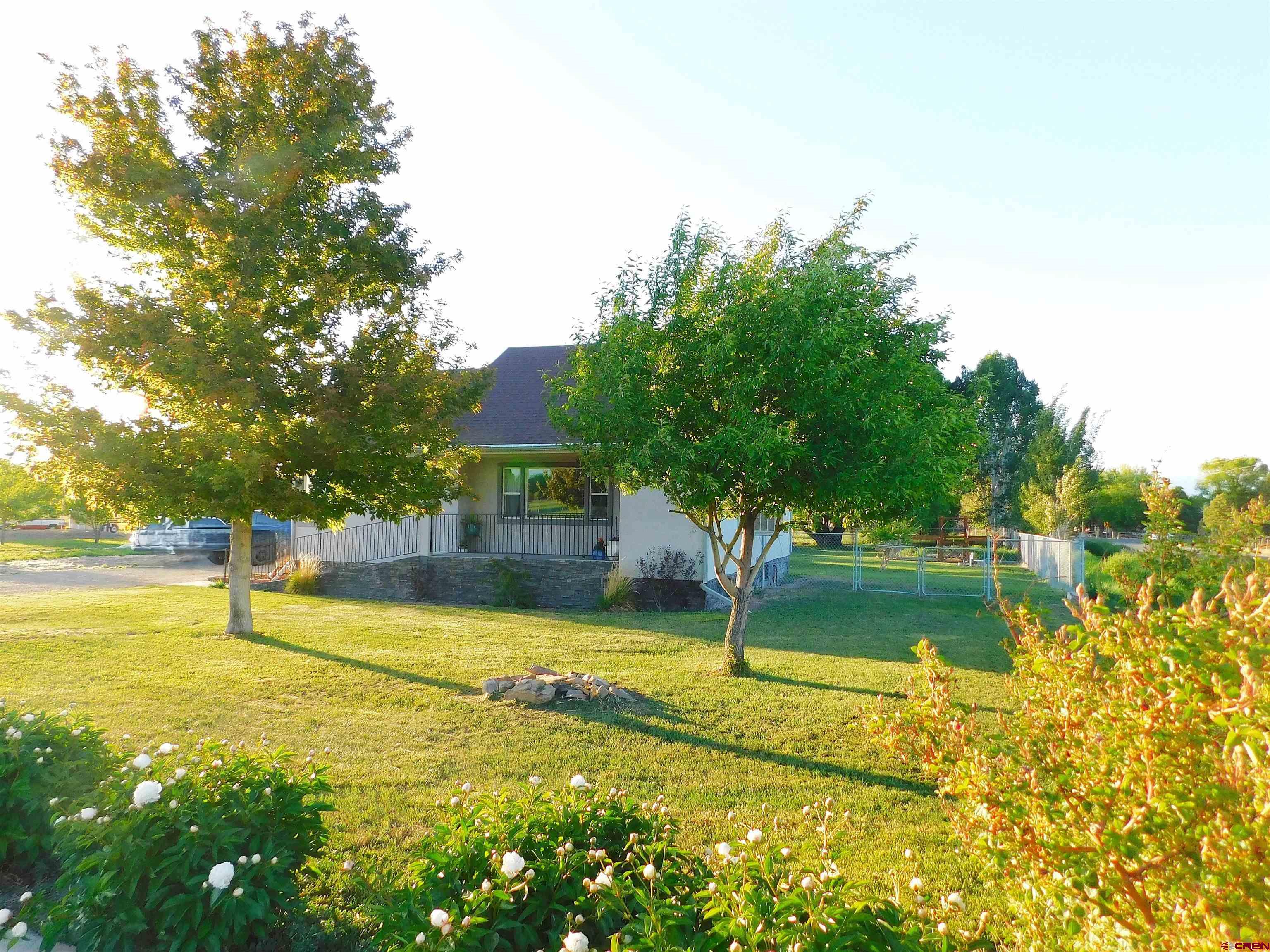 14977 F Road Delta, CO 81416 - Photo 2 of 45 a view of a swimming pool with an outdoor space and seating area