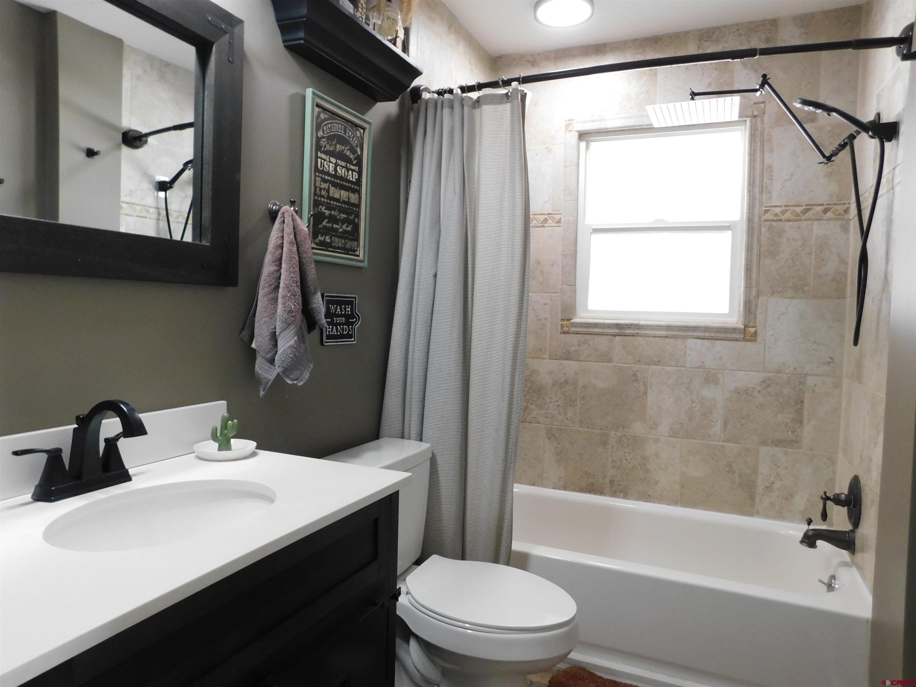14977 F Road Delta, CO 81416 - Photo 21 of 45 a bathroom with a sink toilet and shower
