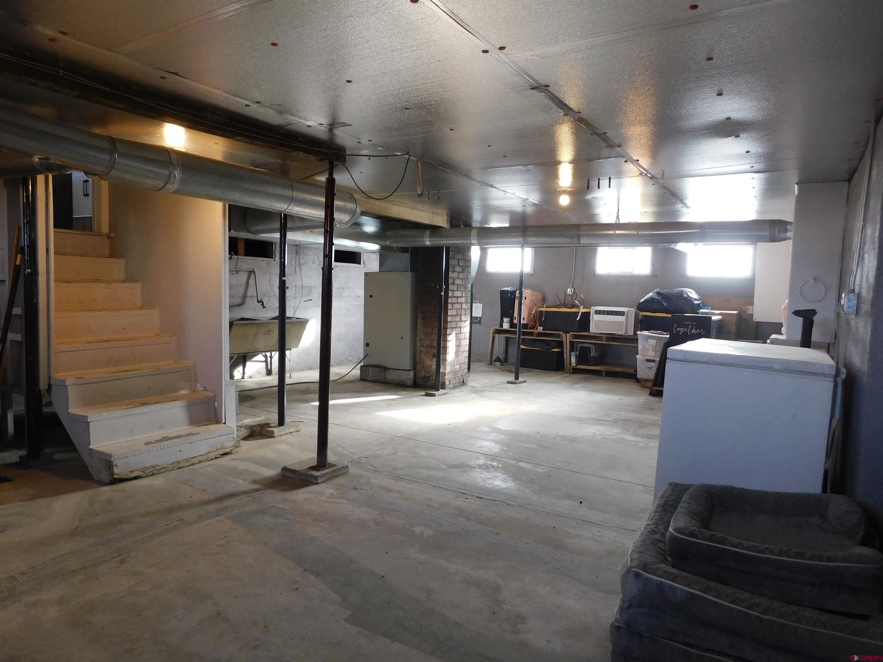 14977 F Road Delta, CO 81416 - Photo 30 of 45 a living room with lots of furniture and a chandelier