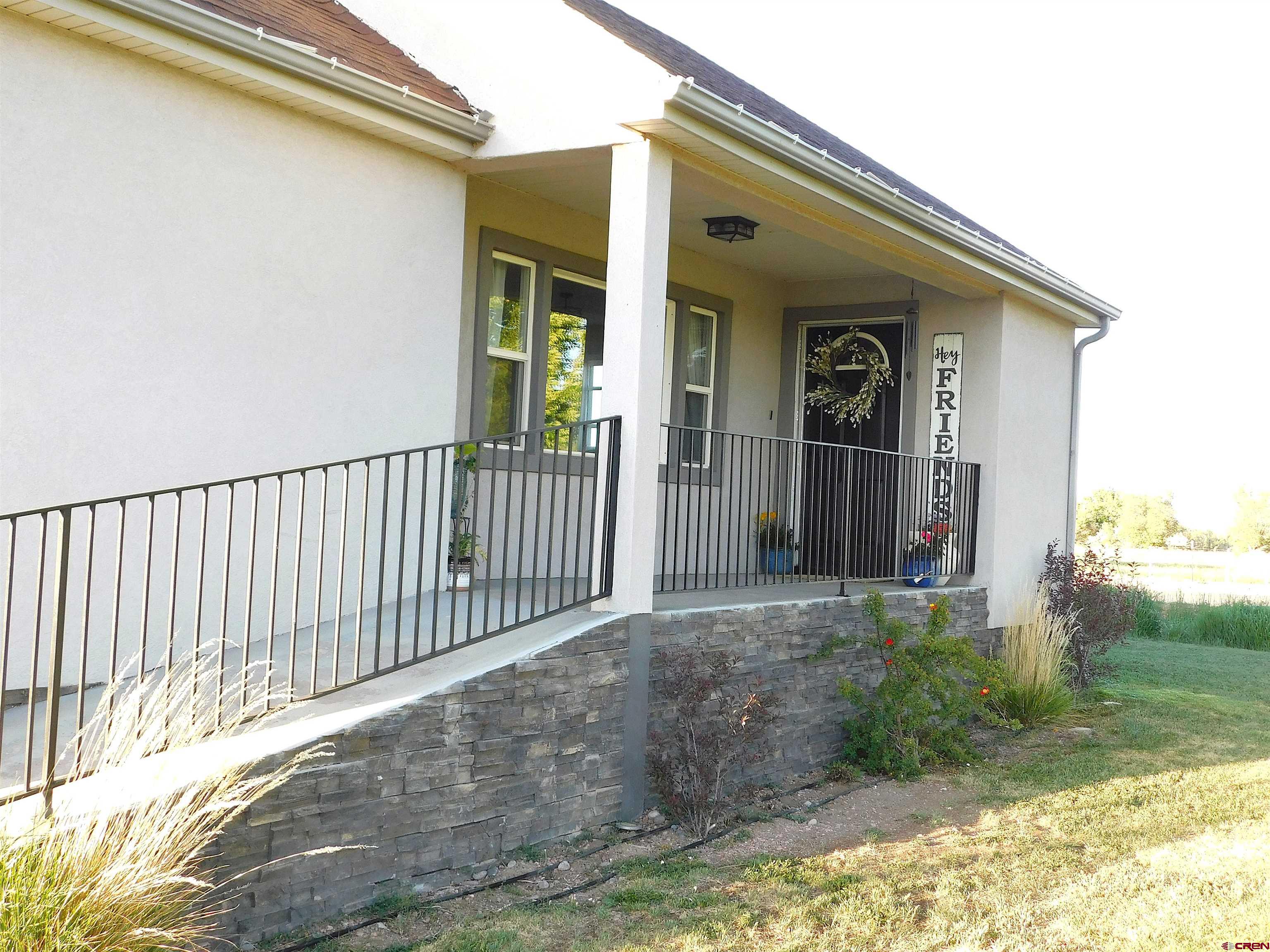 14977 F Road Delta, CO 81416 - Photo 3 of 45 a view of a house with a small yard and wooden floor and fence