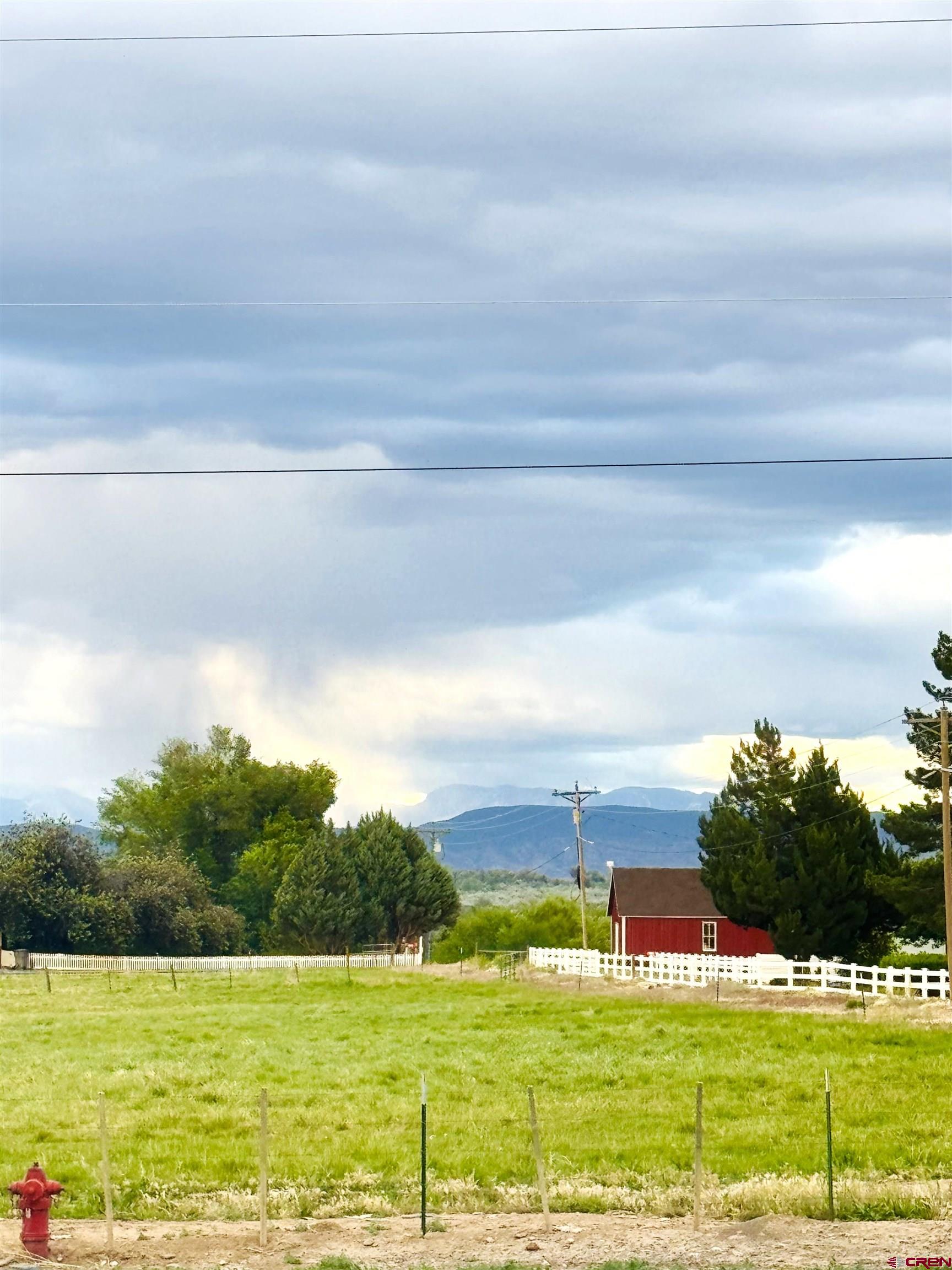 14977 F Road Delta, CO 81416 - Photo 44 of 45 a view of a big room with an outdoor seating a yard and mountain view in back