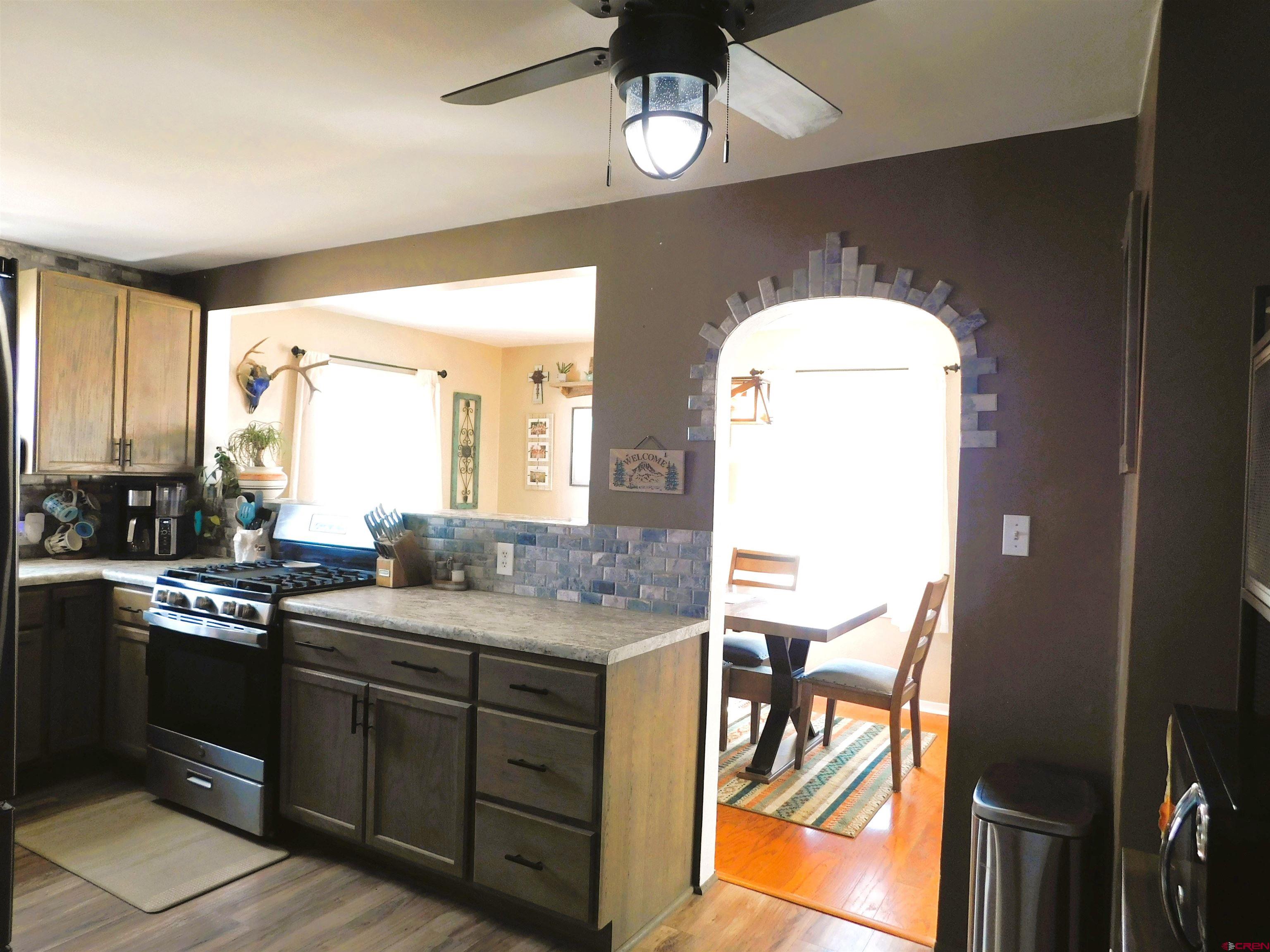 14977 F Road Delta, CO 81416 - Photo 10 of 45 a kitchen with a sink stove and cabinets