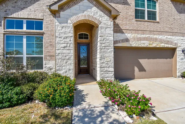 a front view of a house with a garden