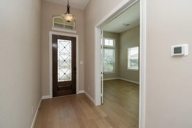 a view of a hallway with wooden floor