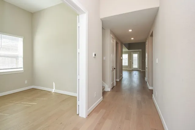 an empty room with windows and closet