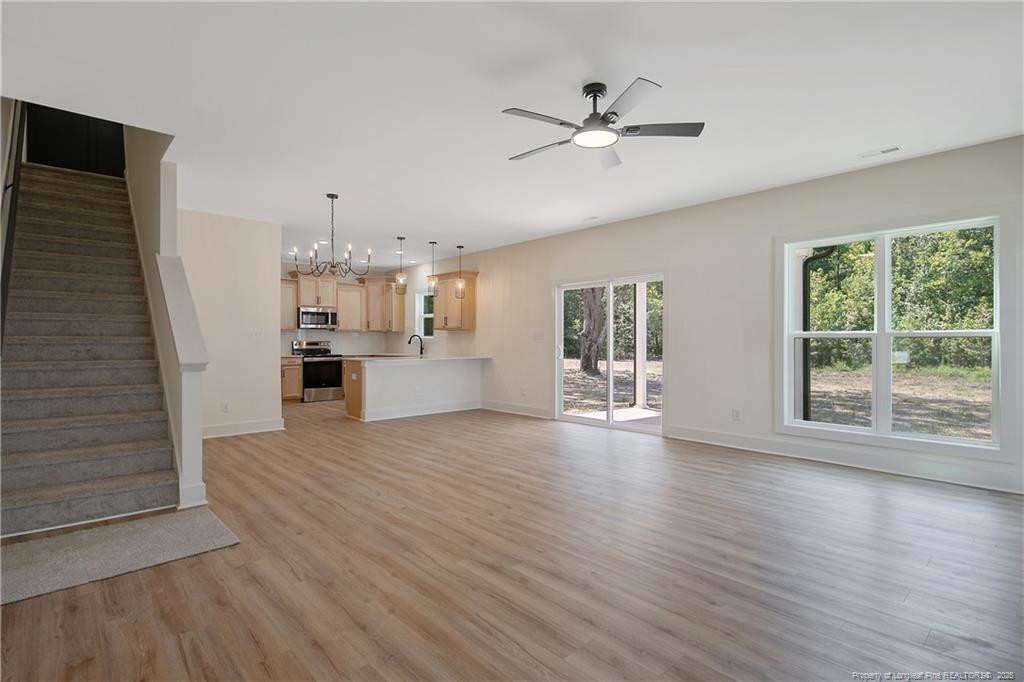 4728 Butler Nursery Road Fayetteville, NC 28306 - Photo 13 of 49 a view of an empty room with wooden floor and a window