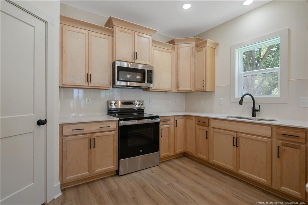 4728 Butler Nursery Road Fayetteville, NC 28306 - Photo 17 of 49 a kitchen with stainless steel appliances granite countertop a stove a sink and a microwave