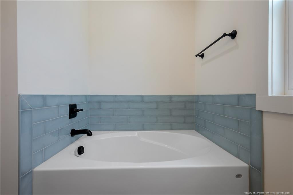 4728 Butler Nursery Road Fayetteville, NC 28306 - Photo 30 of 49 a bathroom with a bathtub