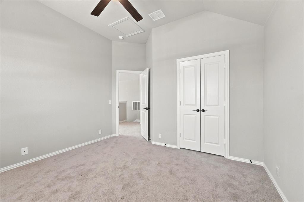 5225 Rowlan Row Midlothian, TX 76065 - Photo 30 of 33 Vaulted ceiling with a ceiling fan, light gray wall finish, light gray carpet flooring, and white bifold doors