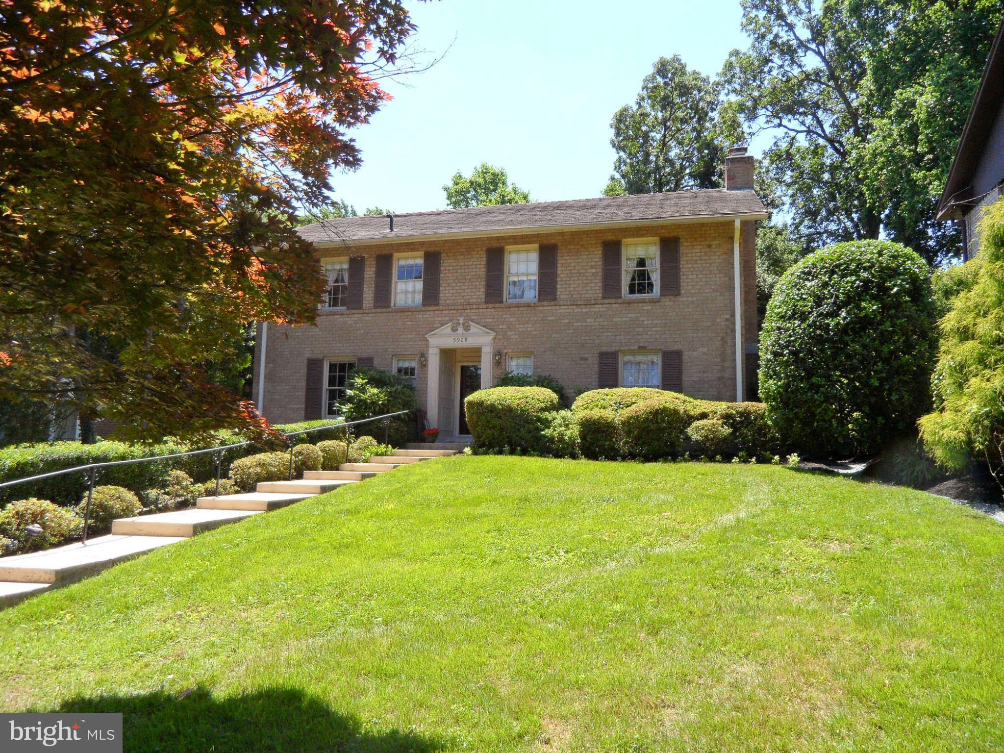 a view of a house with backyard sitting area and swimming pool