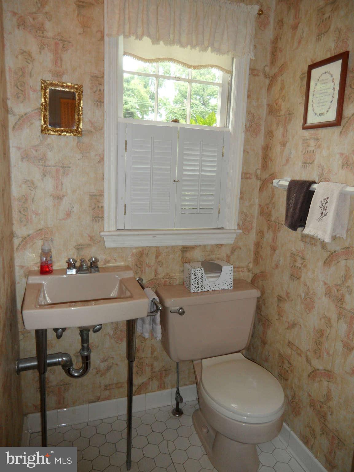 5908 Walhonding Road Bethesda, MD 20816 - Photo 11 of 26 a bathroom with a toilet a sink and a window