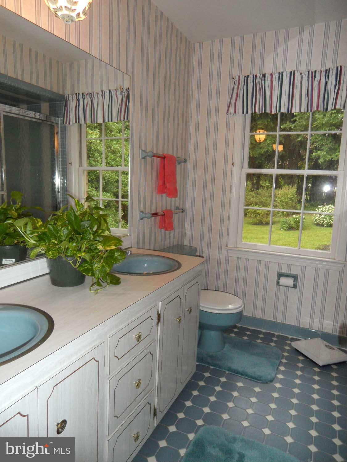 5908 Walhonding Road Bethesda, MD 20816 - Photo 16 of 26 a bathroom with a sink a toilet and shower