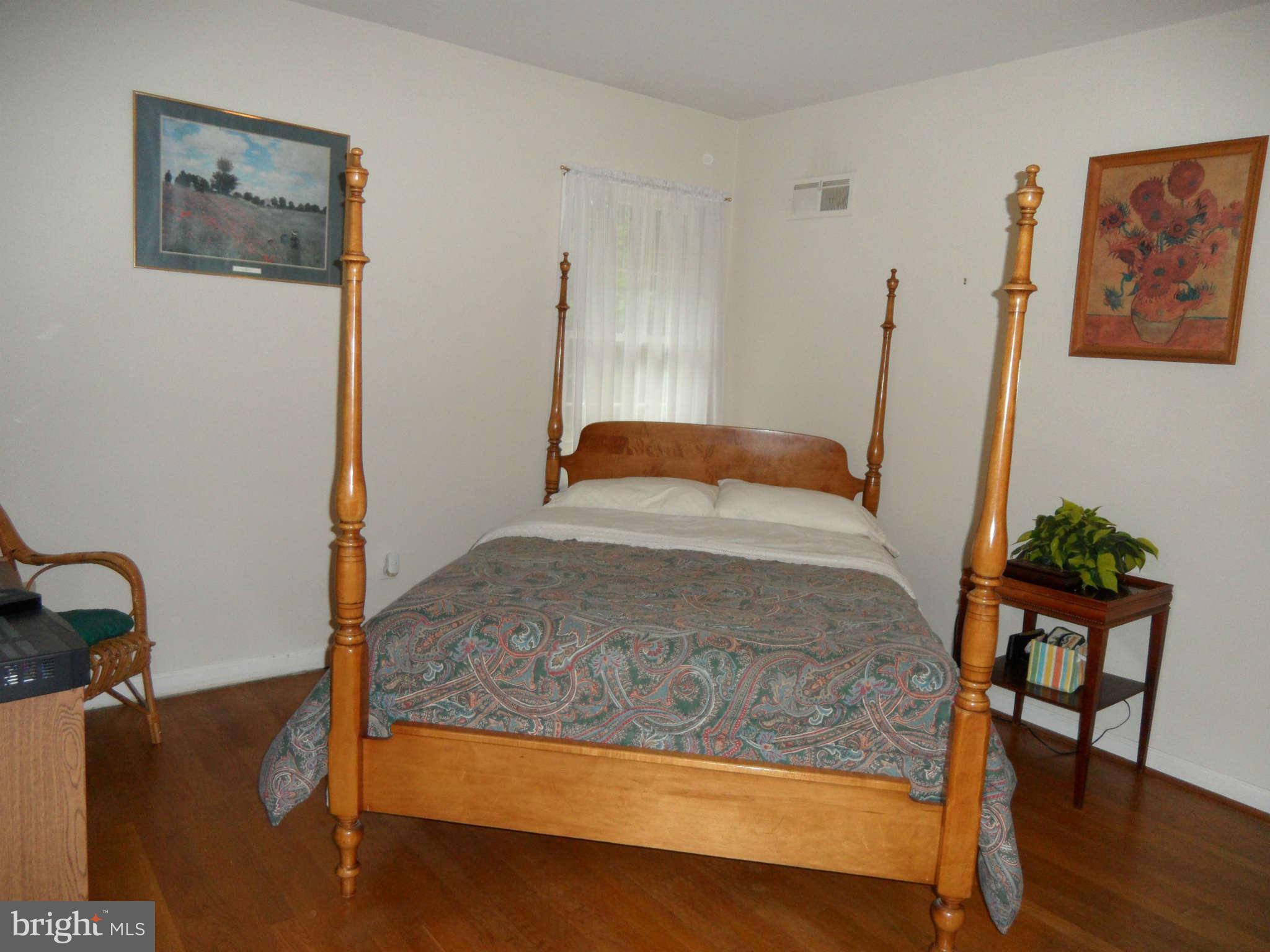 5908 Walhonding Road Bethesda, MD 20816 - Photo 19 of 26 a bedroom with a bed and wooden floor