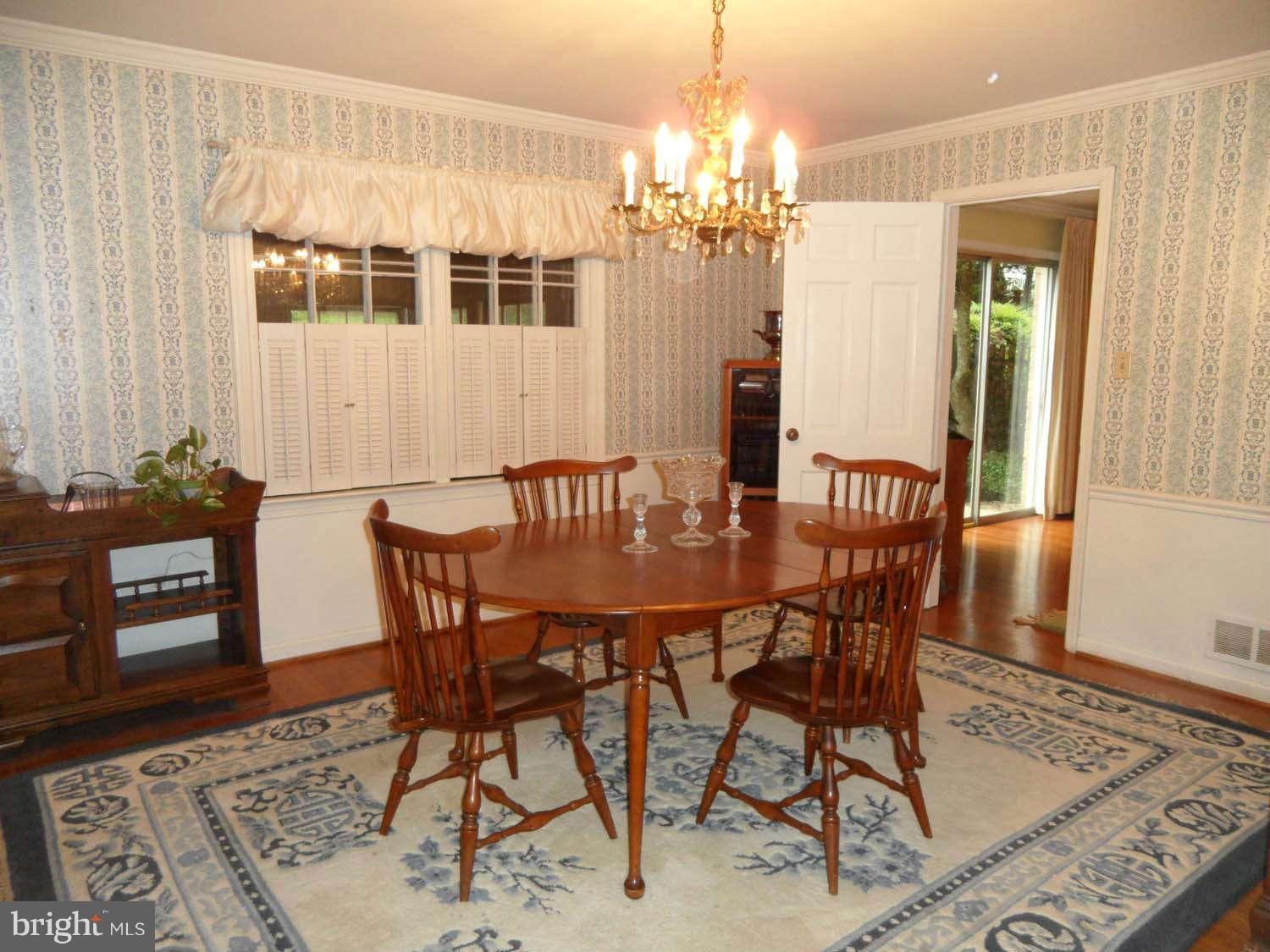 5908 Walhonding Road Bethesda, MD 20816 - Photo 6 of 26 a view of a dining room with furniture and chandelier