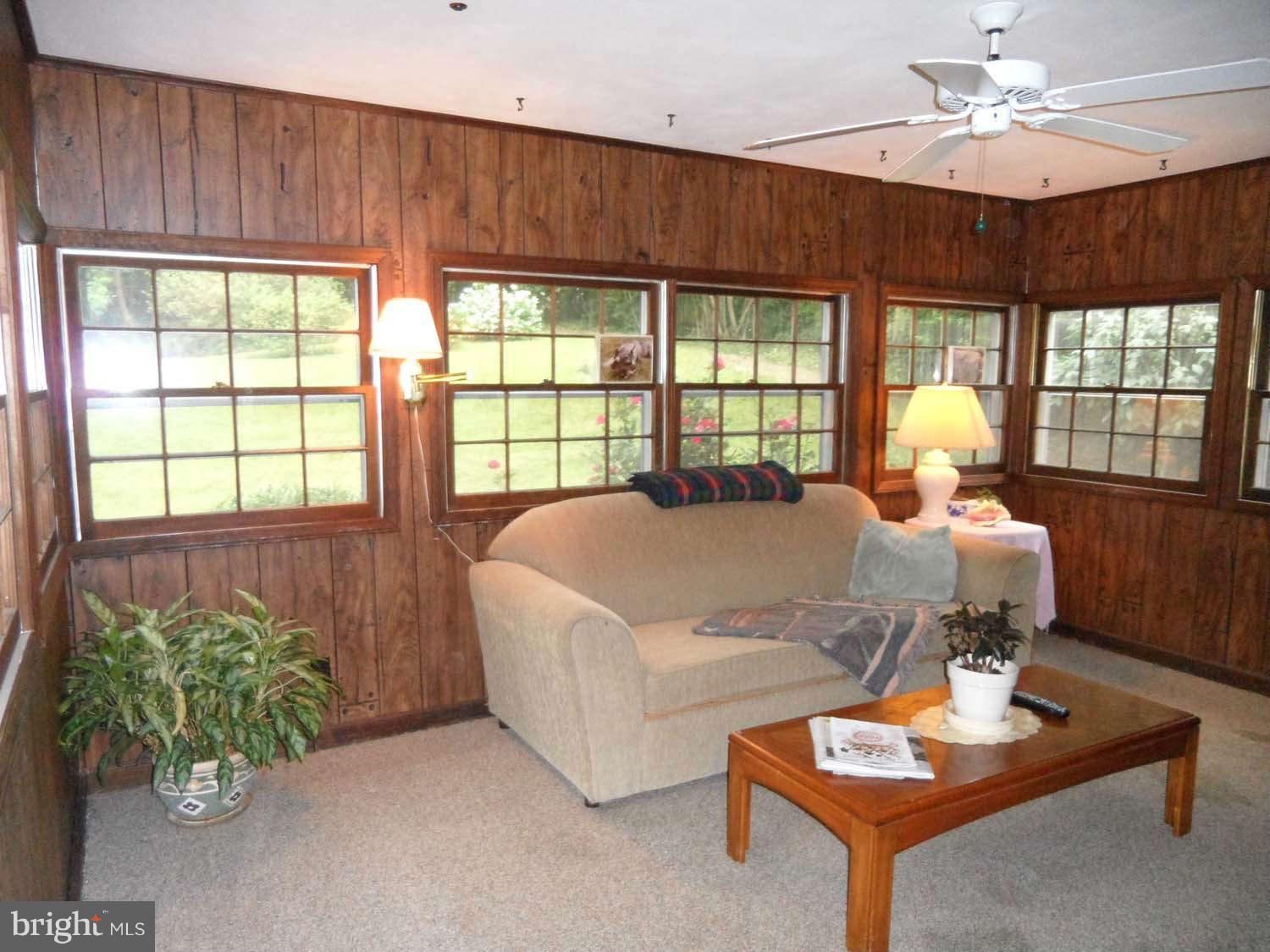 5908 Walhonding Road Bethesda, MD 20816 - Photo 10 of 26 a living room with furniture and a potted plant