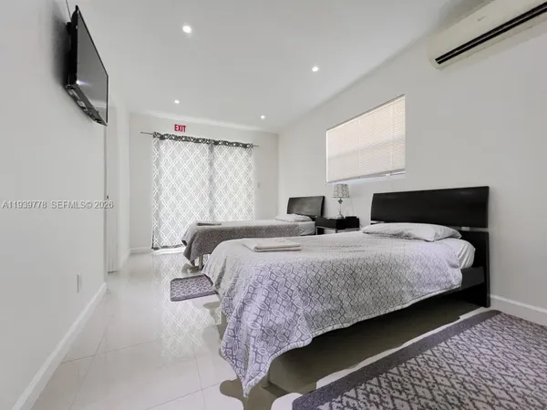 a bedroom with bed and window