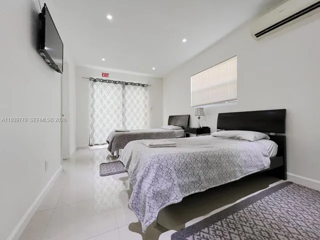 a bedroom with bed and window