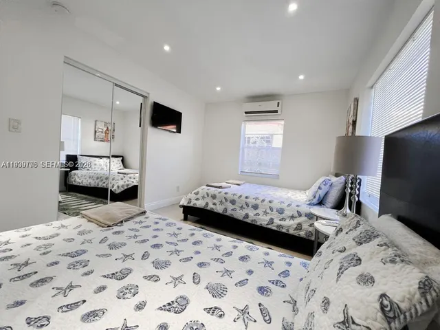 a bedroom with bed and mirror