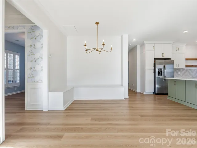 a view of a room with wooden floor and a bathroom
